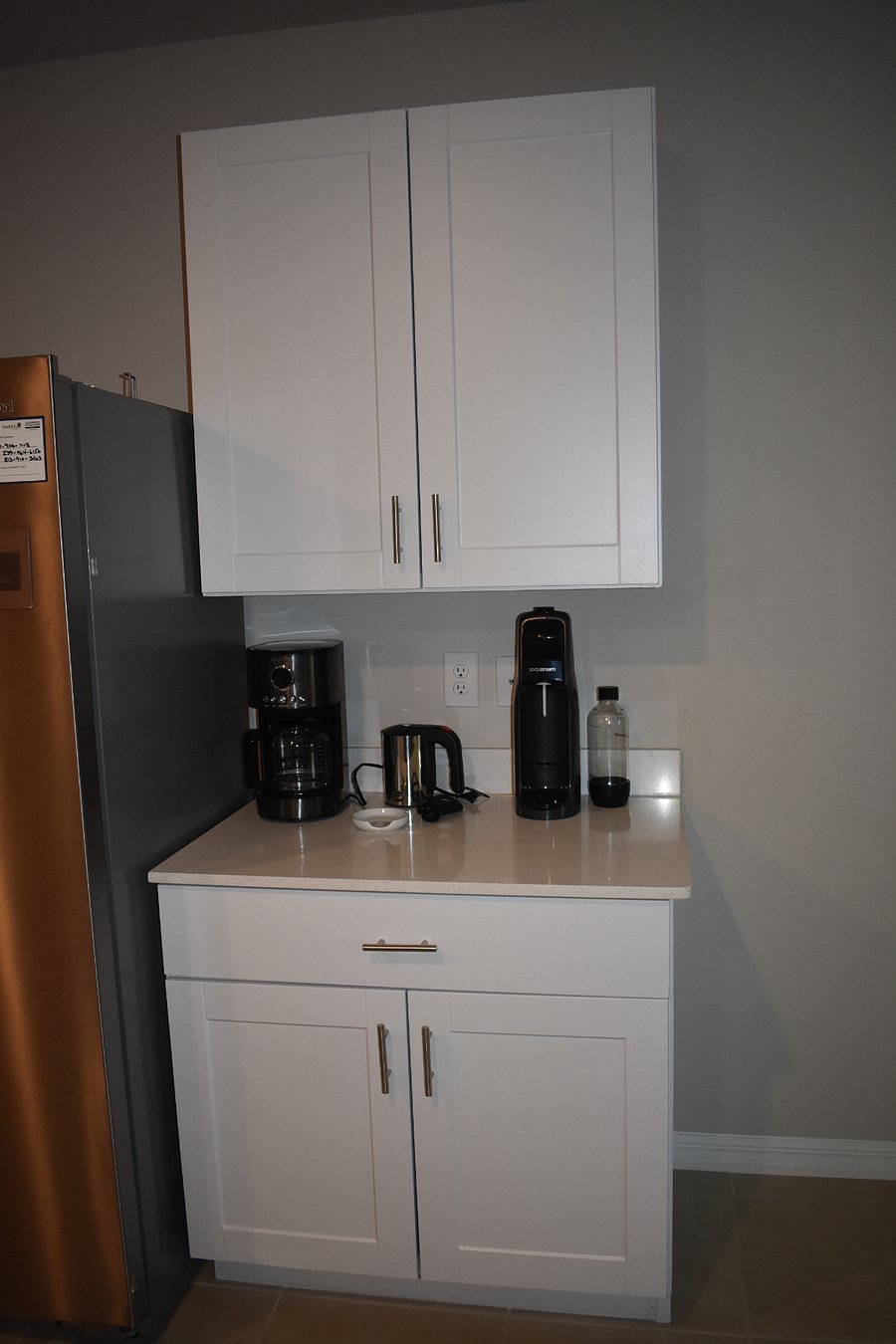 Coffee station in kitchen - coffee maker, soda stream, electric hot water kettle