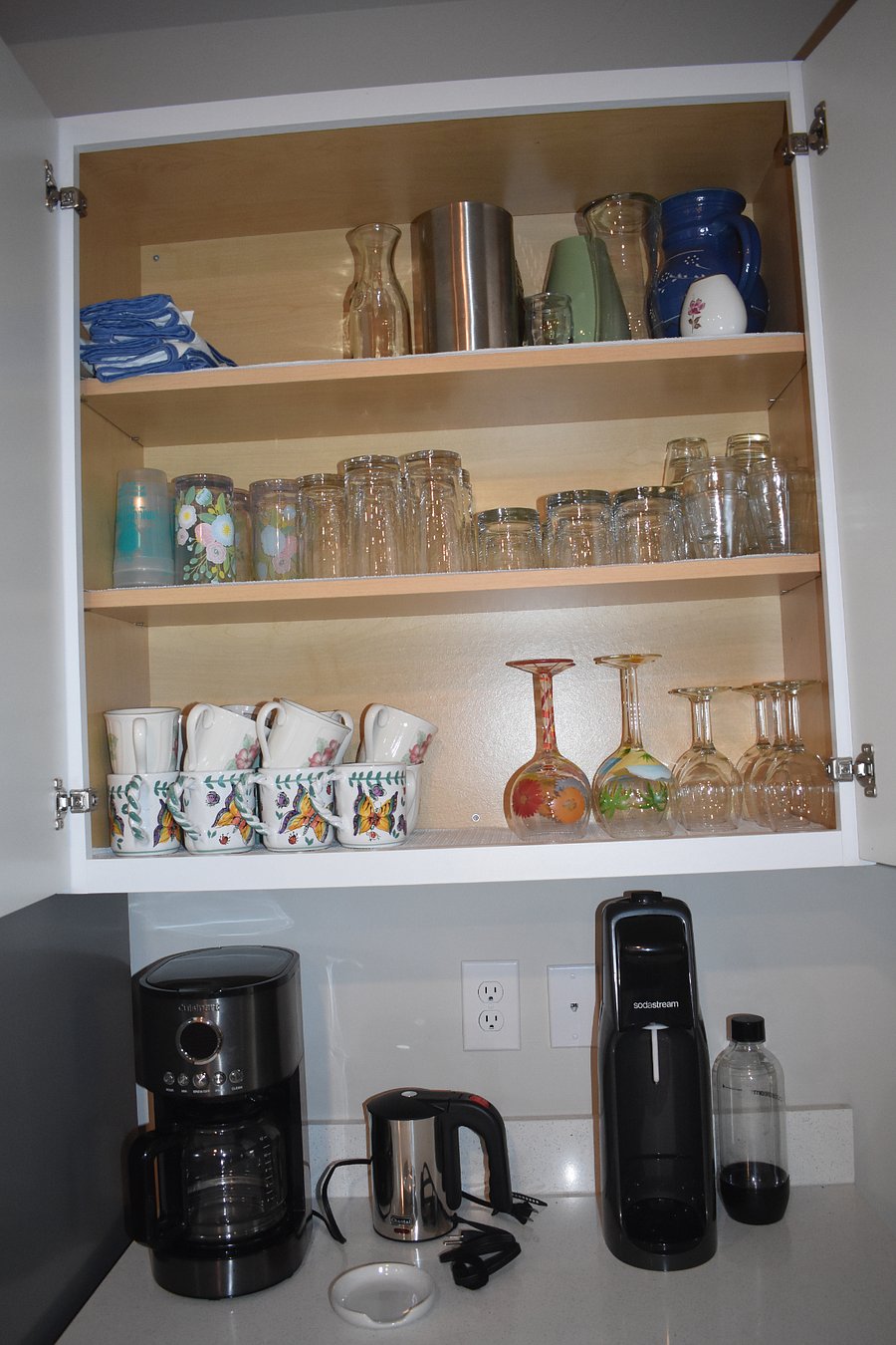 Cups & drinkware above coffee station