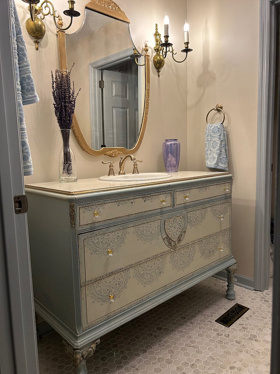custom designed antique vanity and mirror add to the French touch