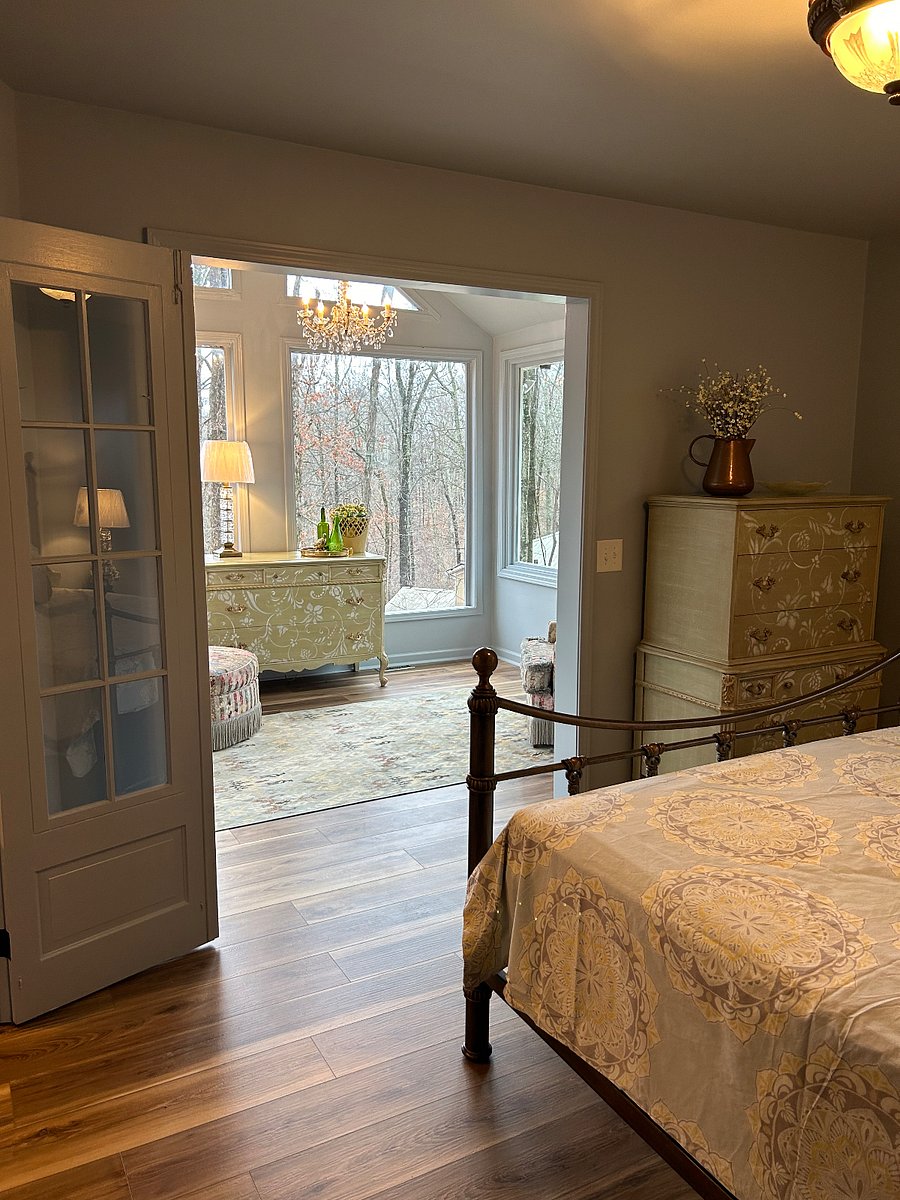 Primary bedroom with queen bed and blackout window coverings.