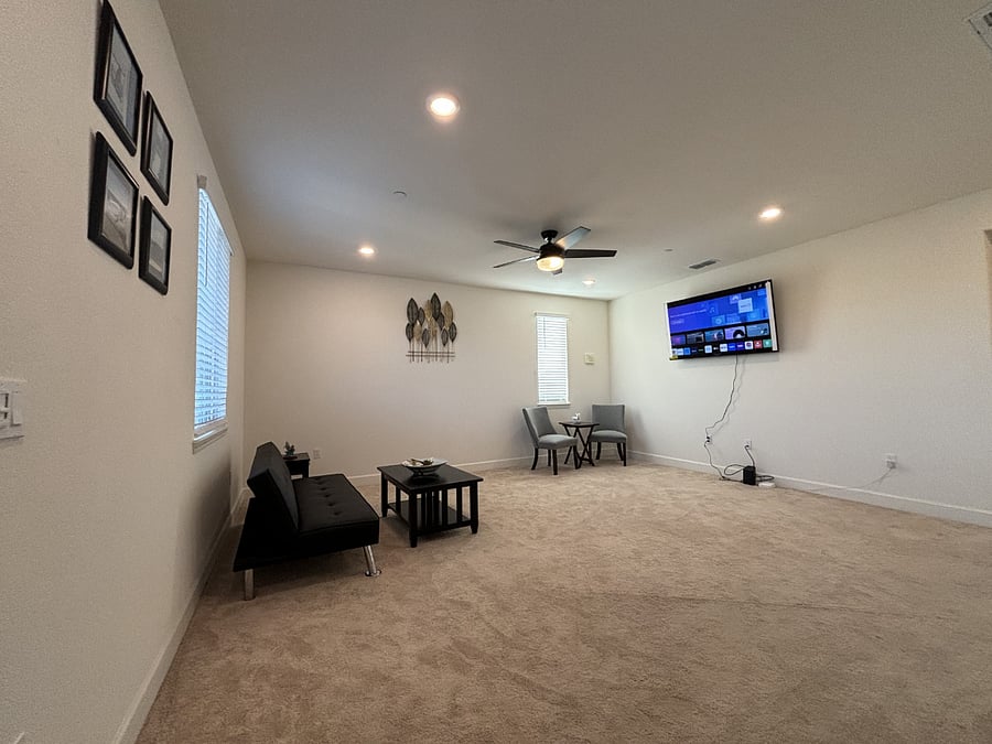 Huge loft upstairs set up as a second living room or entertainment area.