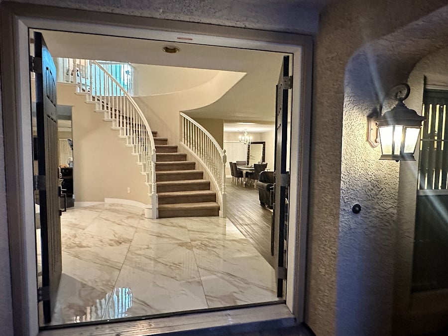 Grand entrance double doors, stairway to second floor and bedrooms