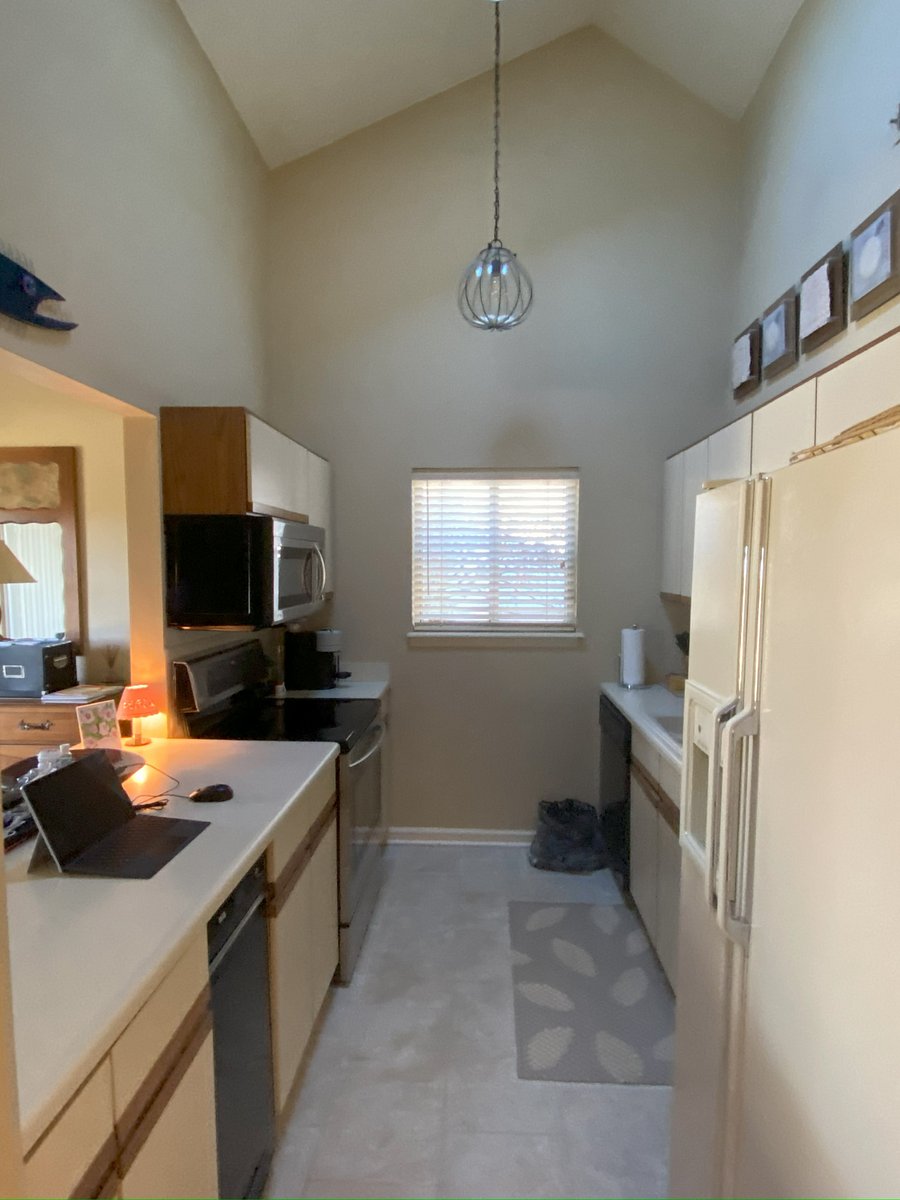 Galley kitchen - small and easy to clean with new microwave, oven/stove and includes a trash compactor