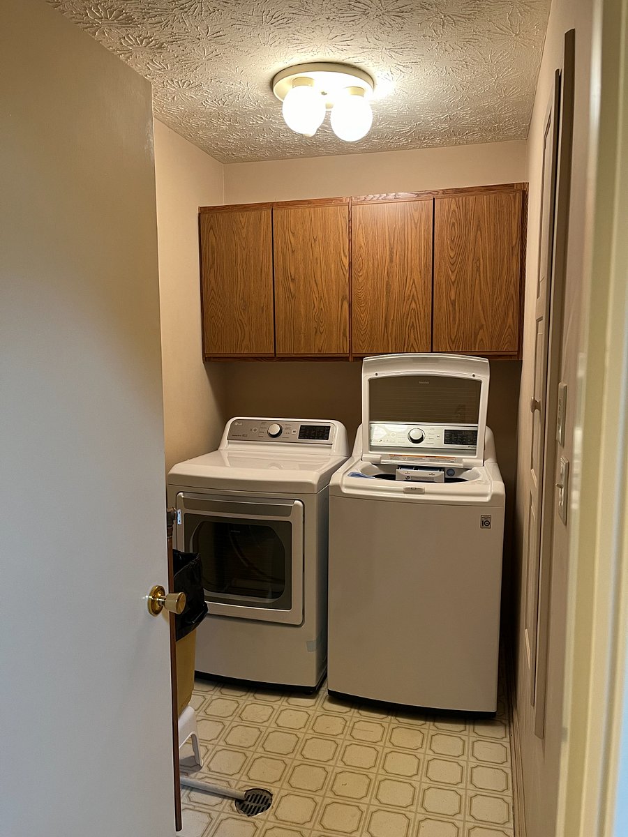 Laundry room with new LG washer and dryer. Built in ironing board on wall. Water heater also in this room