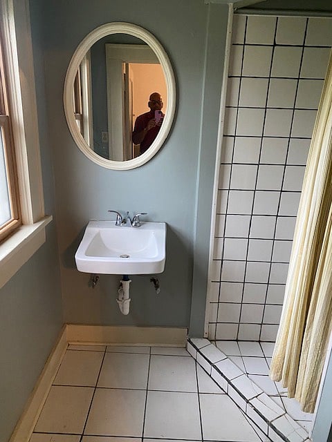 A private bathroom with a shower and other amenities attached to the bedroom. 