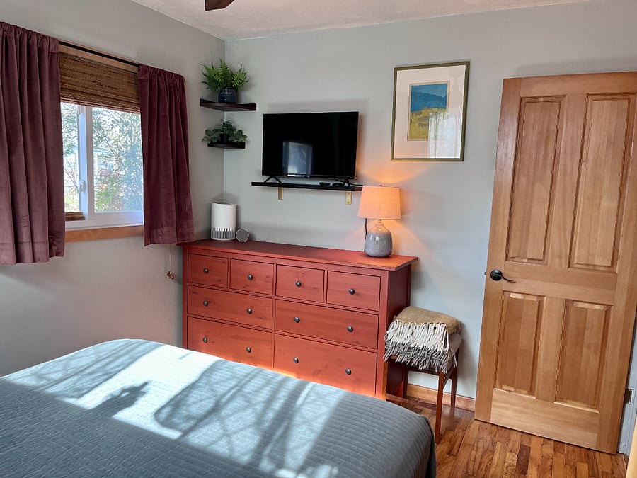primary bedroom / blackout curtains / 32" Roku TV with Netflix
