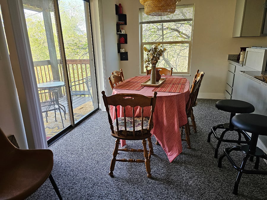The Balcony, A six seat dining table, and a bar with stools that spin
