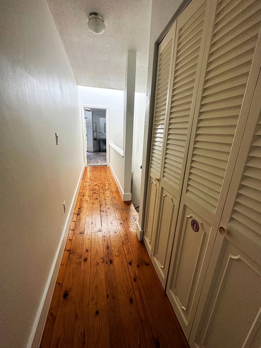 Two Upstairs Bedrooms with Private Bathrooms Separated by Large Hallway