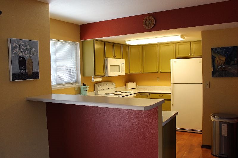 Fully equipped kitchen with window and new appliances.