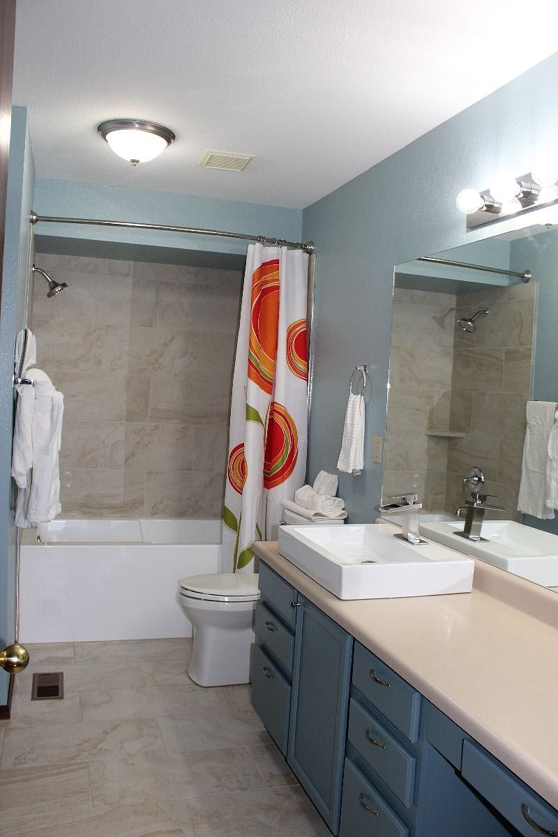 Upstairs full bathroom with soak-in bath and his and hers sinks.