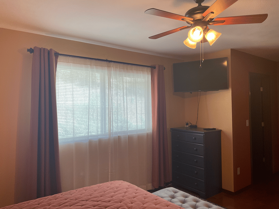 Master bedroom with King bed and wall-mounted smart TV.