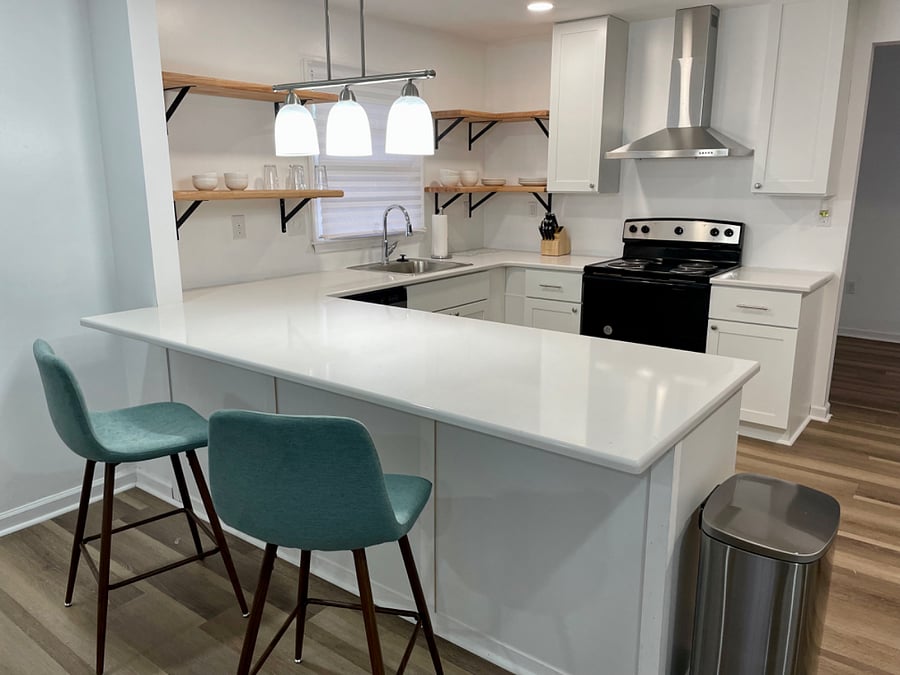 Large open kitchen with quartz countertops and stainless appliances 