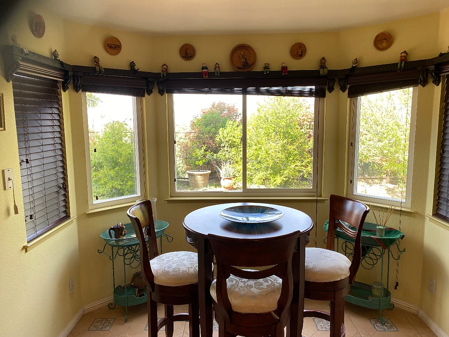 Kitchen nook with table and bay window with garden view