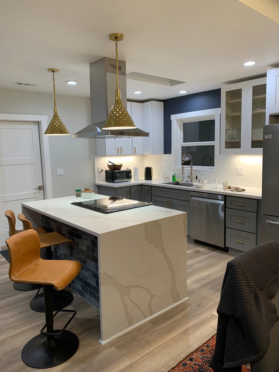 Kitchen with door to finished garage, laundry, work area.