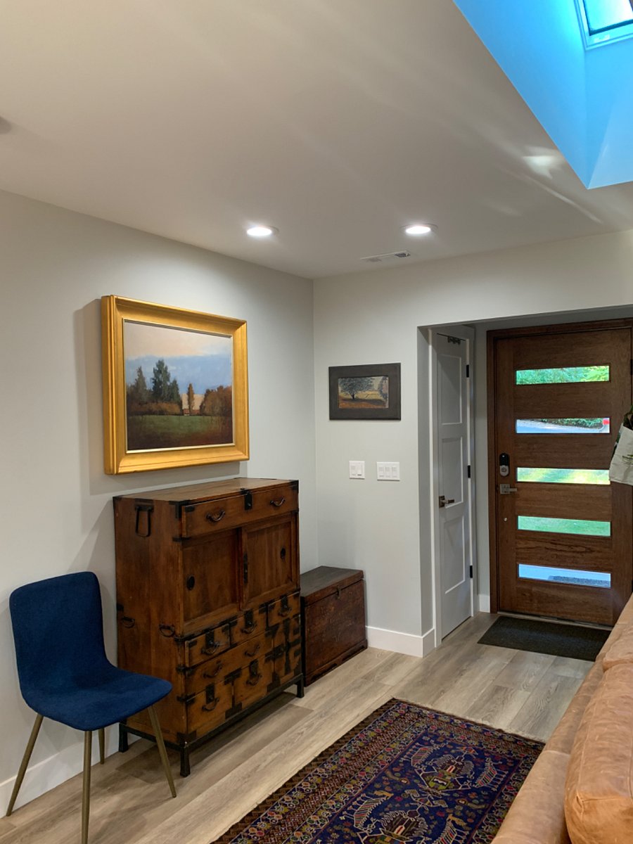 Entry, we have different painting and table in entry area, closet for coats by front door...