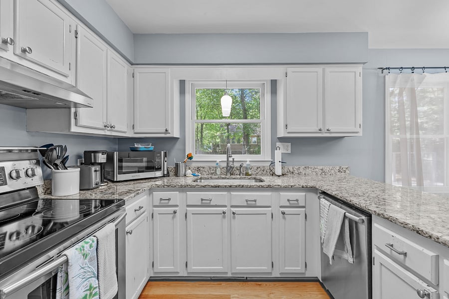 Updated kitchen with stainless steel appliances (refrigerator, electric stove/oven, dishwasher, and farmhouse sink)