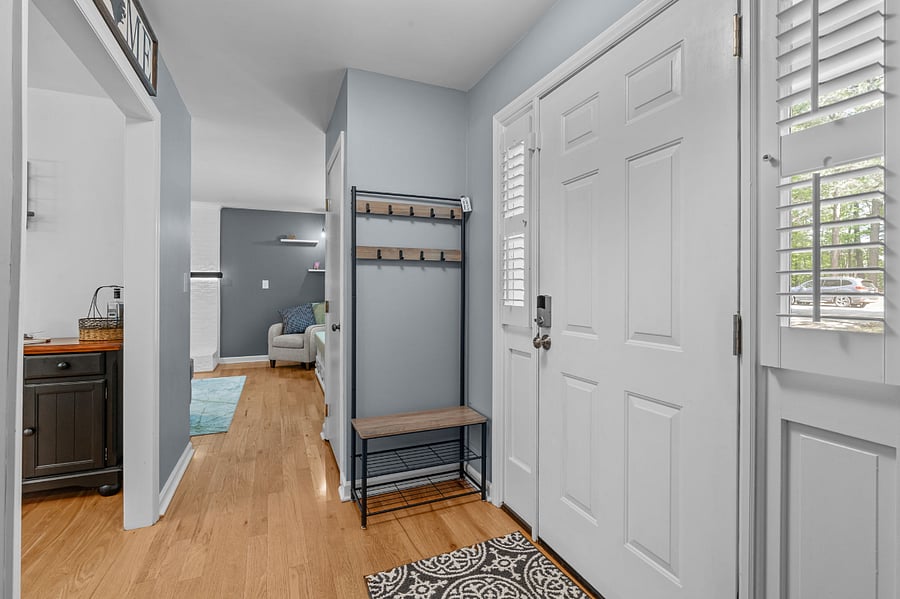 Entryway with coatrack and shoe caddy.