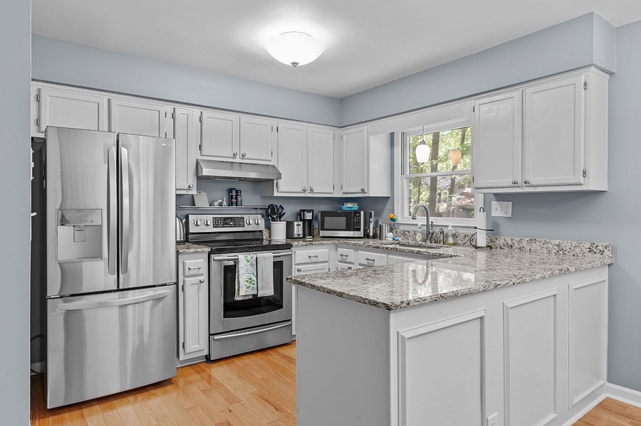 Updated kitchen with stainless steel appliances (refrigerator, electric stove/oven, dishwasher, and farmhouse sink)