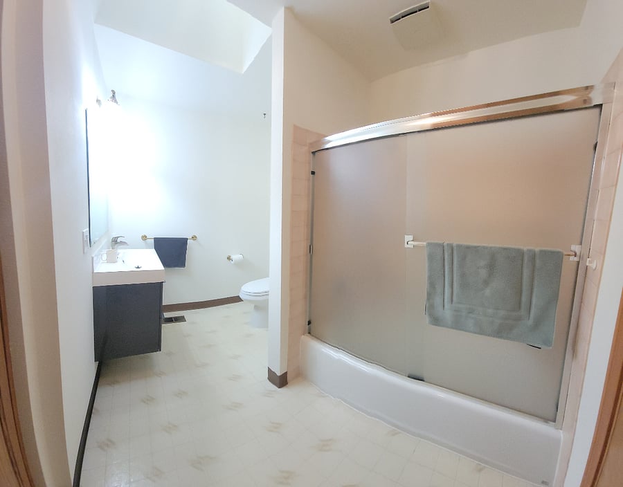 Large bathroom with tub/shower, skylight, and lots of storage