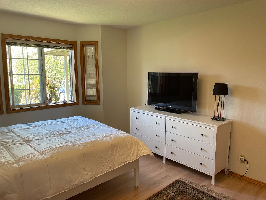 Bedroom with large screen TV with cable.