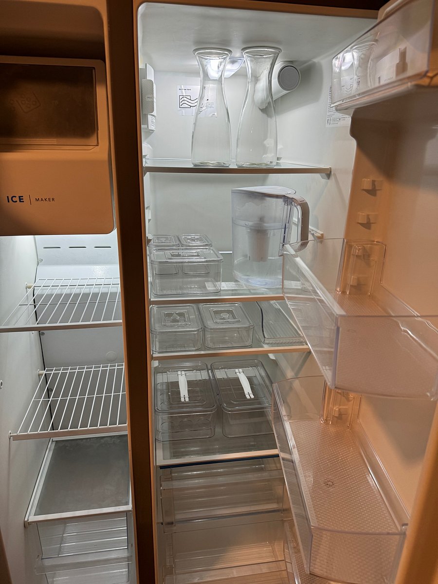 Fridge with food storage containers and pitchers.