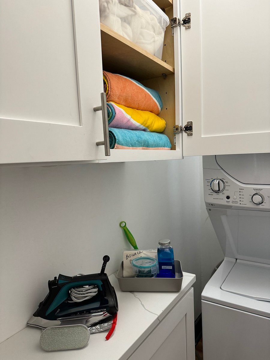 Laundry with starter laundry detergent pods, softener, sanitizer and beach towels provided