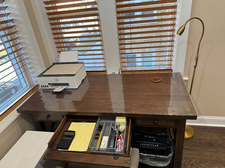 desk in living room with basic liquid ink printer and amazon basic shredder and starter office supplies provided.