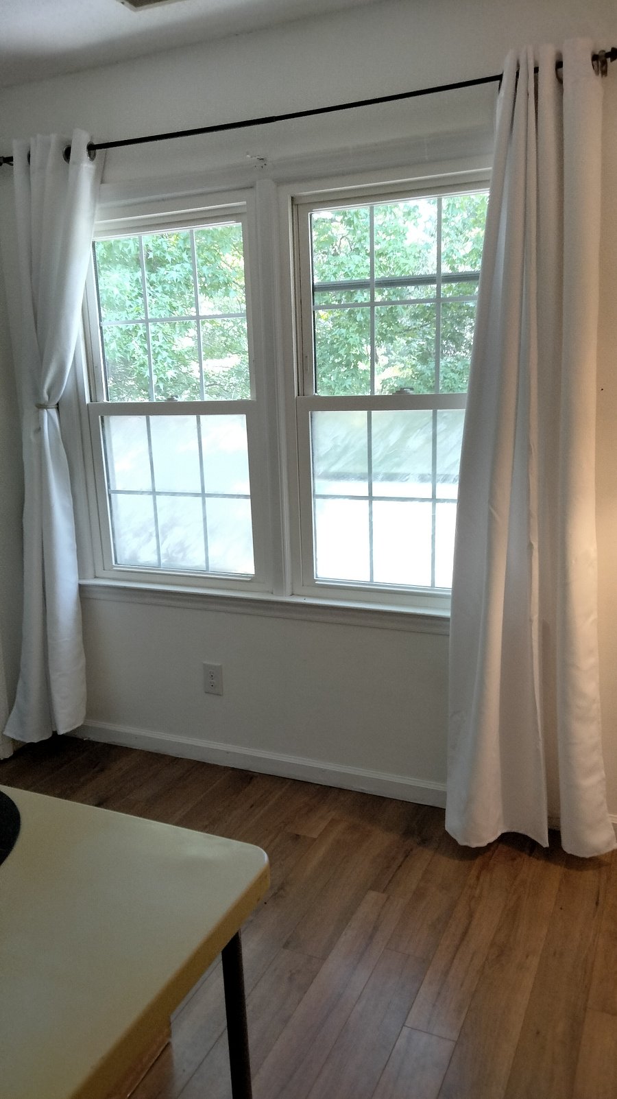 Windows facing front yard, with curtains