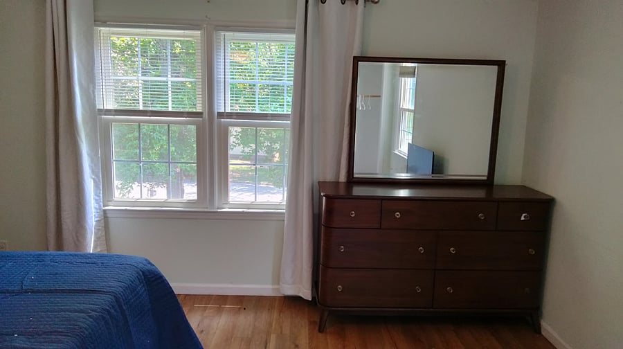 Dresser and windows facing front yard