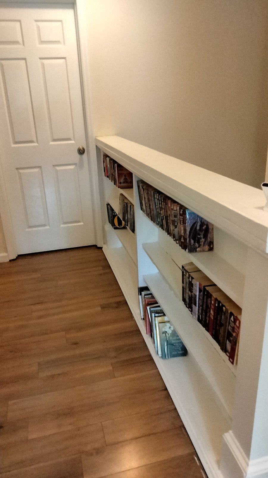 Bookshelves in 2nd floor hallway and door to MBR / other rental unit
