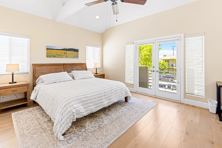 Primary bedroom with small balcony overlooking street.