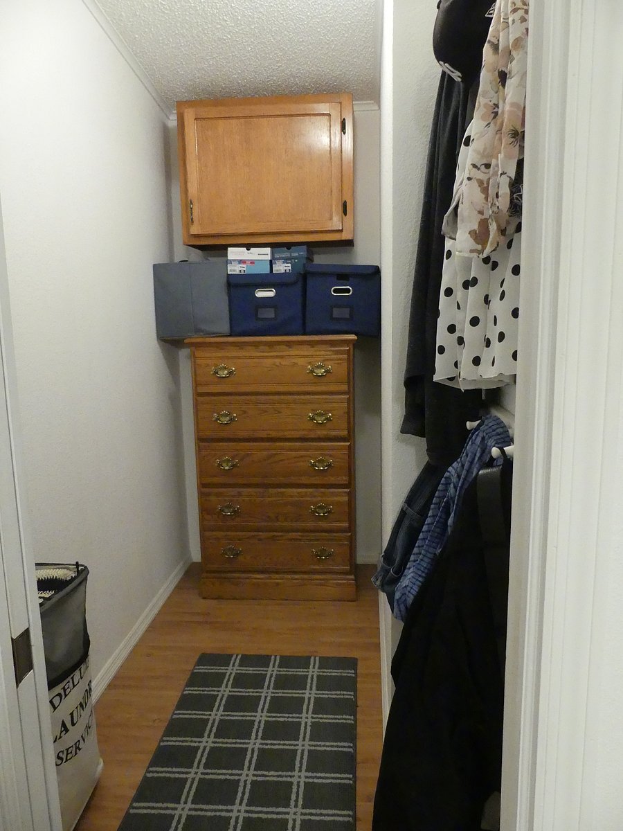 walk in closet area of master bedroom