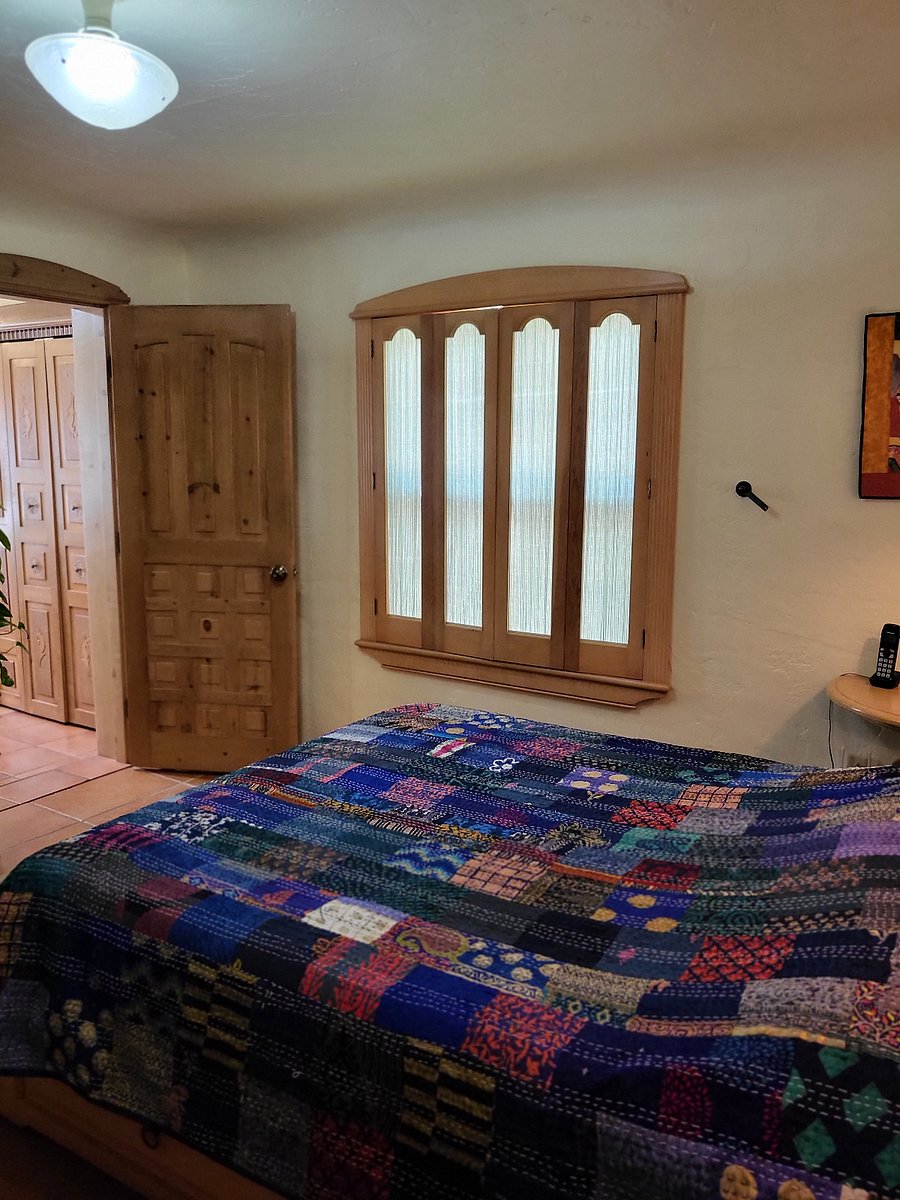 Master bedroom 2 - shutters & door to bathroom. There's a 4" step down into the bathroom.