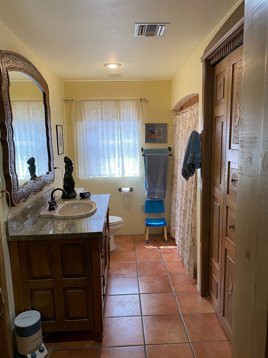 Bathroom between master bedroom and guest bedroom. Bathroom has large closet for storage & hanging clothes.