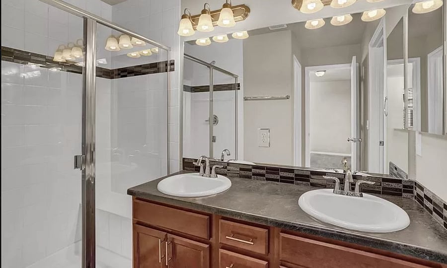 Private bathroom with walk-in shower and bench shower seat. Double sinks