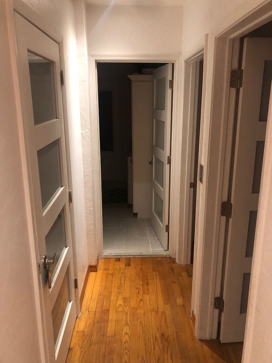 Hallway facing entrance to bathroom
