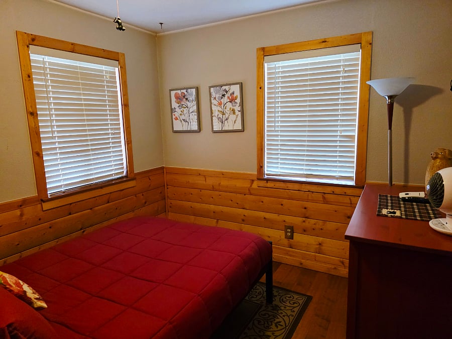 This alternate view of the spare bedroom showcases classic wood craftsmanship and inviting bedding. Its the perfect cozy retreat to relax and recharge before exploring the town and surrounding mountains. 