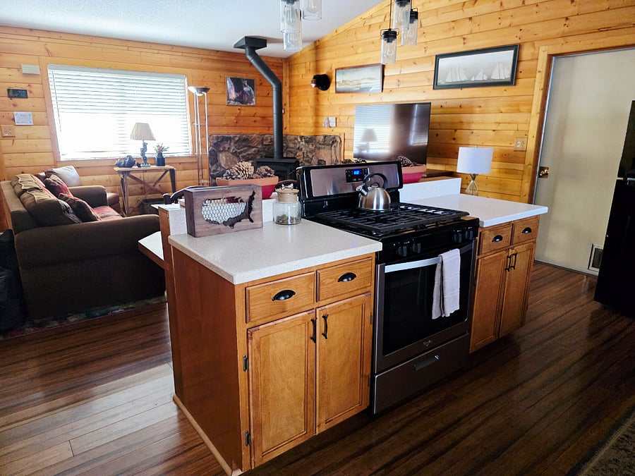 Check out the kitchen island overlooking the living room! Guests love cooking, socializing, and staying connected hereits the perfect space for families and friends to gather together. 