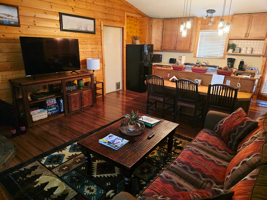 Guests love the cozy sofa bed and the open-concept living room and kitchen layout! The seamless flow between spaces makes it ideal for groups, creating a bright and inviting atmosphere for relaxing, cooking, and making memories together. 