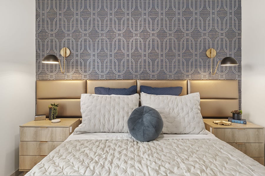 Cushioned wall bed panel for comfort and stylish bedside reading sconces.