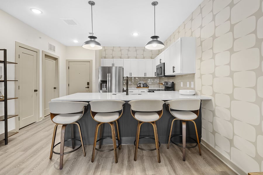 Quartz counters and stainless steel appliances in the kitchen.