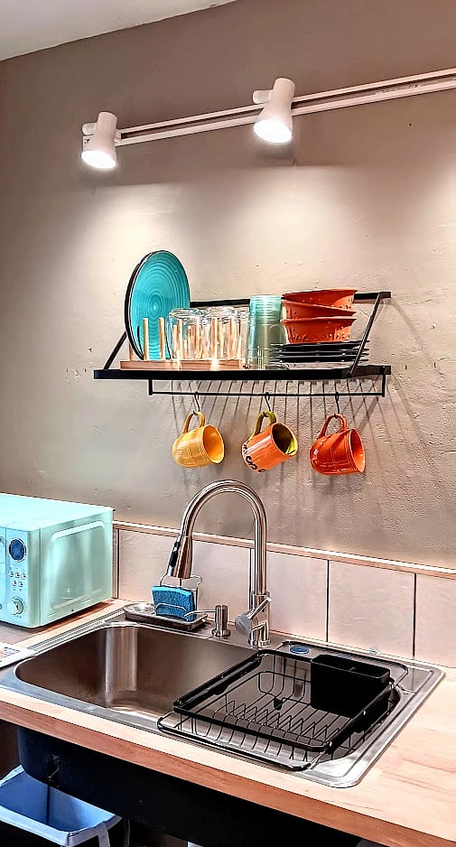 Generous sink with strainer, all kitchen utensils, plates, etc., microwave, Keurig coffee maker with coffee pods