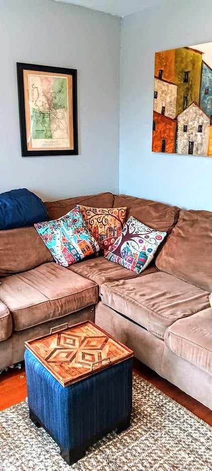 Generous L-shaped comfy couch in a bright and sunny livingroom with a 43-inch LG smart TV (with access to Netflix).