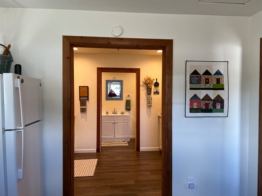 From the Second entrance which is a utility area leads to the kitchen and bathroom straight ahead. To the right is the entrance to the living room and two bedrooms.