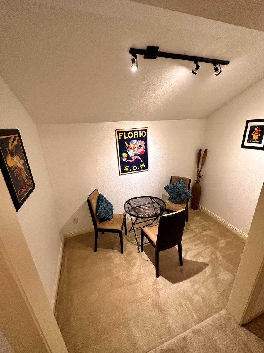 At the top of the stairs just past the entrance is a separate eating/working area with a table and chairs. A separate dedicated workspace or eating area which also has hooks for umbrellas jackets keys or backpacks/ bags