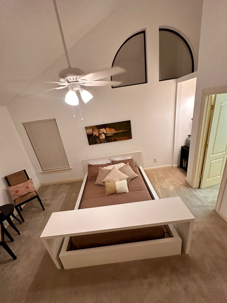 Bedroom has a small sitting area