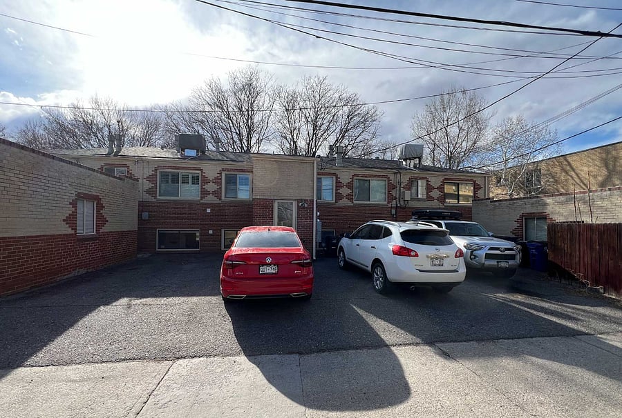 Assigned parking space is where the red car is parked. Right outside the back door to the building.
