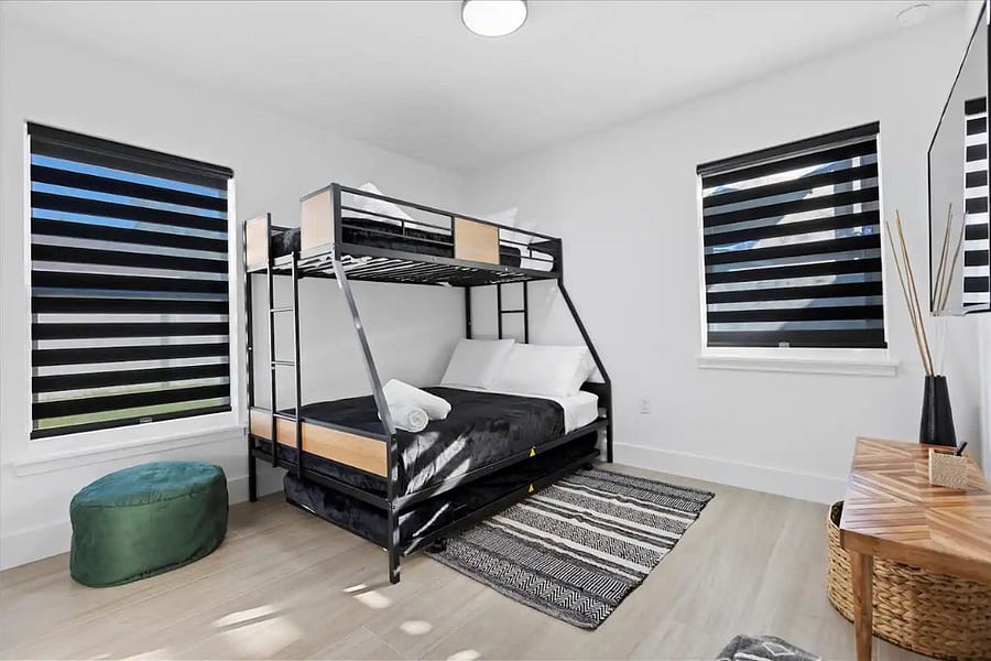 Bunk beds with the rolling trundle under the bottom.
