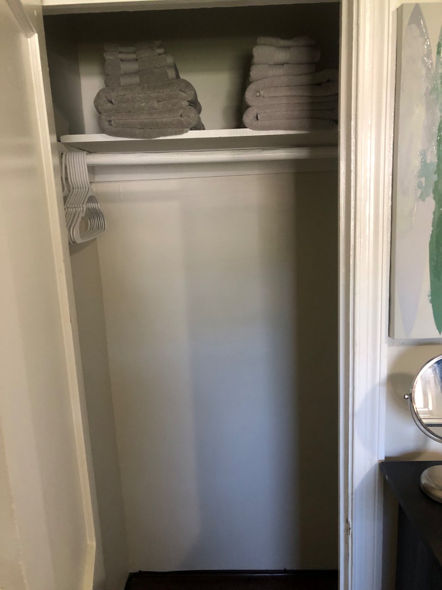 The closet in each room has hangers and towels.