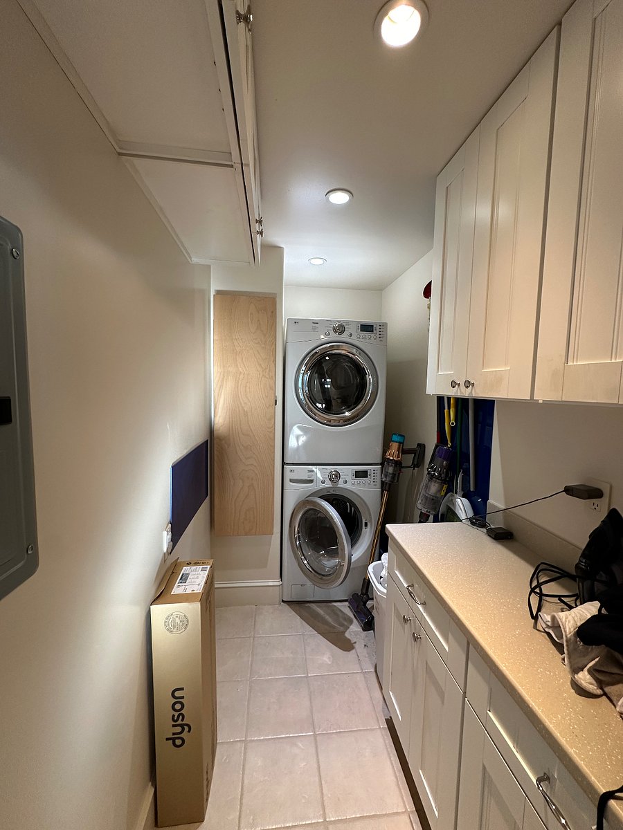 Shared laundry room with ironing board